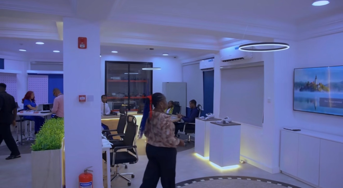 Wider view of the Miva Open University Robotics & Innovation Laboratory, with workstations, display plinths and people at work