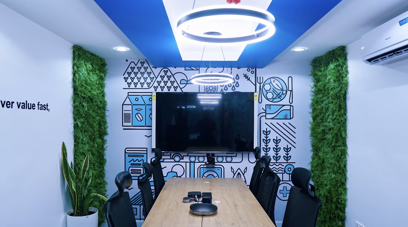 Roche Abuja workplace meeting room with a conference table and wall-mounted screen